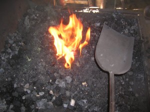 When coal is burning, rake windrows of green coal up to edges of fire and tamp down with a shovel.